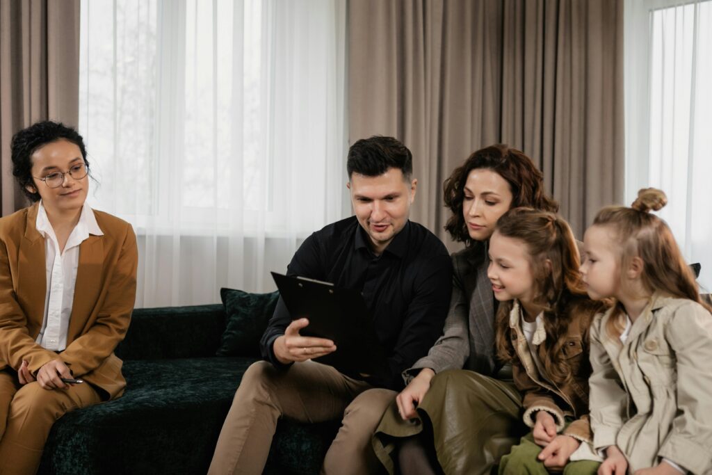 pexels-photo-7642028-7642028 A family receiving advice from a professional advisor indoors, focused on financial planning.